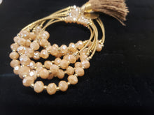 Load image into Gallery viewer, Cream colored crystal Bangle with ornament and hanging heart shaped pendant