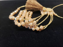 Load image into Gallery viewer, Cream colored crystal Bangle with ornament and hanging heart shaped pendant