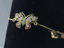 Cargar imagen en el visor de la galería, Hollow tipped Butterfly with blue and clear crystals (bracelet)