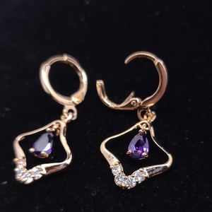 Hollow diamond shaped with hanging purple crystal