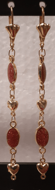 Red oval crystals with laminated hearts