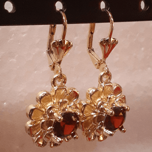 Small laminated flowers with red centered crystals